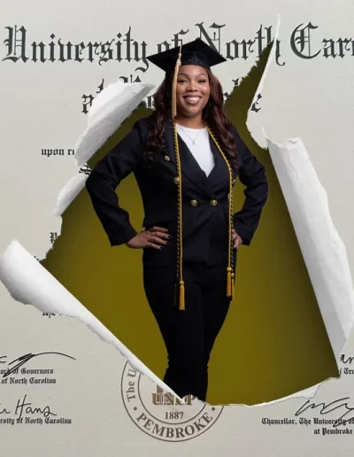 A woman in graduation attire stands confidently through a tear in a University of North Carolina diploma background.